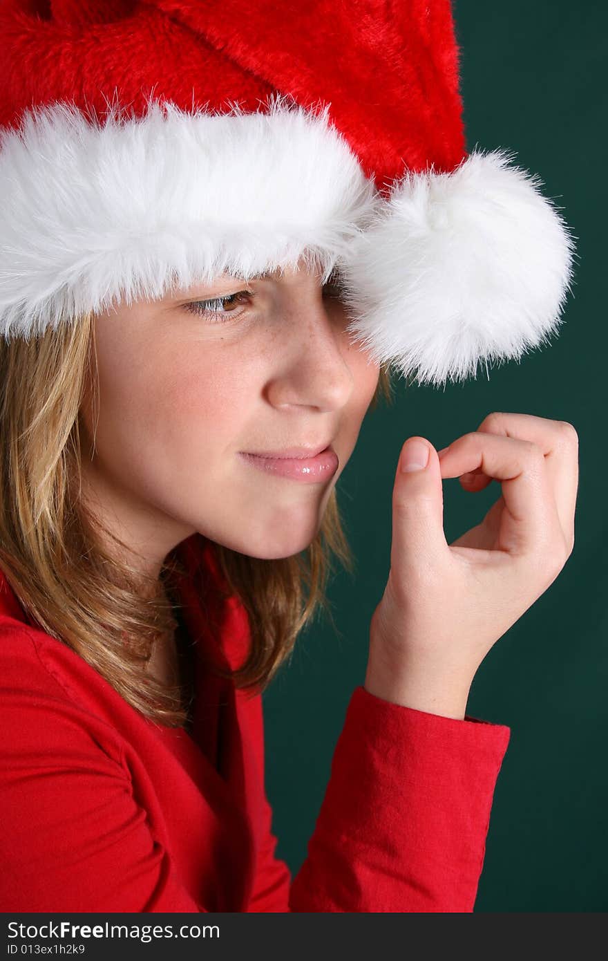 Teenager in red shirt and fluffy christmas hat. Teenager in red shirt and fluffy christmas hat