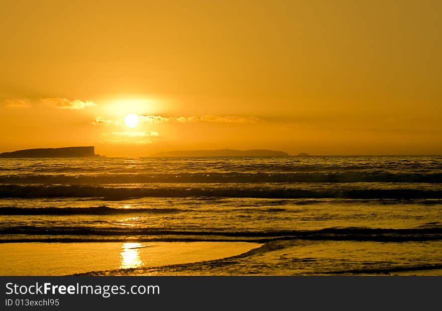 Lovely coastline sunset with island silhouettes on the horizon. Lovely coastline sunset with island silhouettes on the horizon