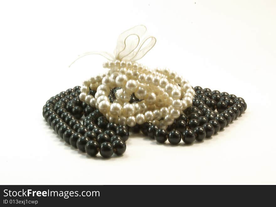 Black beads and white braclet on white background