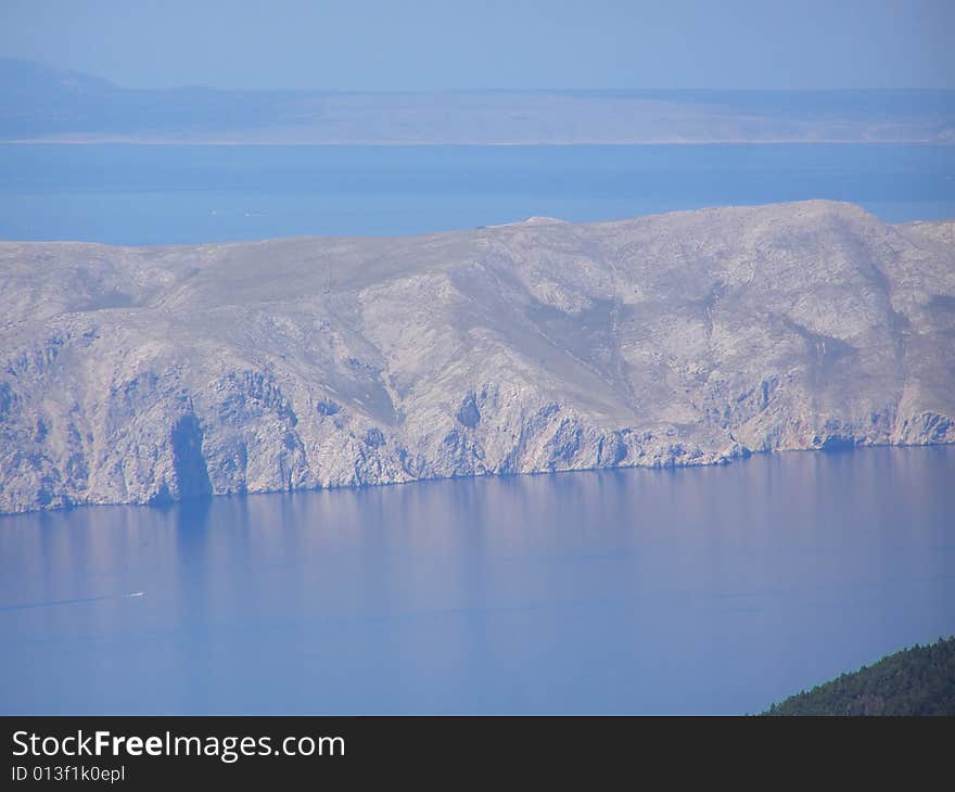 Croatia - view from the Velebit Mountain (Vratnik Pass) to the Adriatic Sea and Kvarner Bay - islands of Krk and Cres in the background. Croatia - view from the Velebit Mountain (Vratnik Pass) to the Adriatic Sea and Kvarner Bay - islands of Krk and Cres in the background