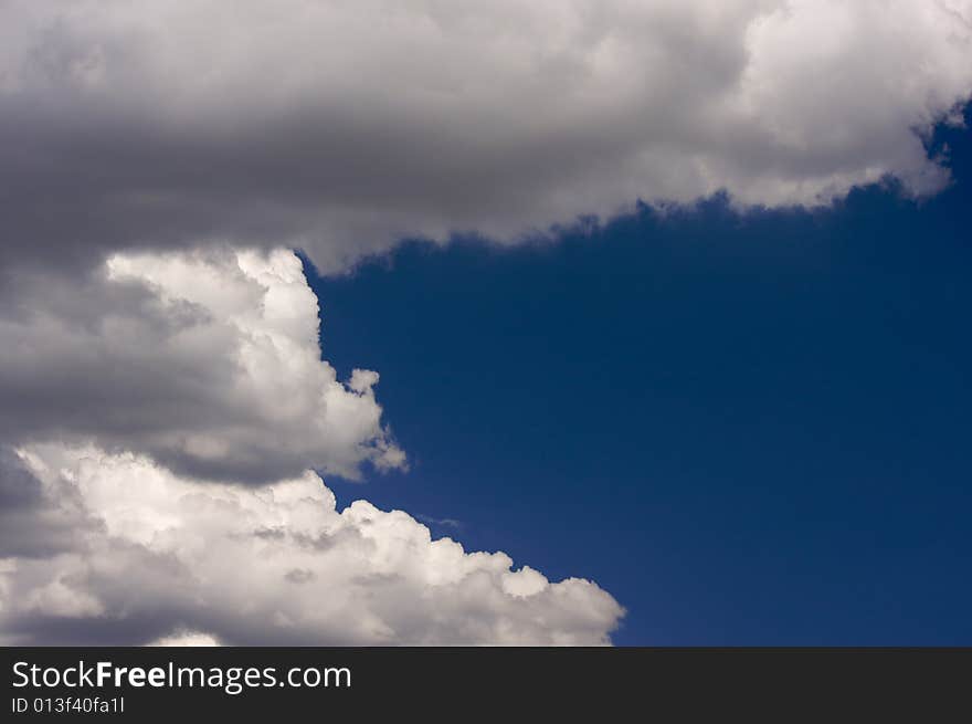 Puffy Clouds On A Blue Sky.