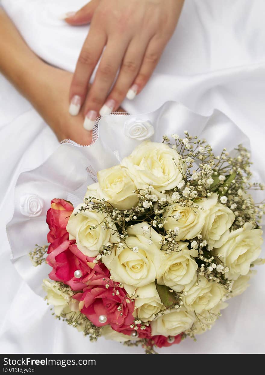 Wedding bouquet of roses holding by bride