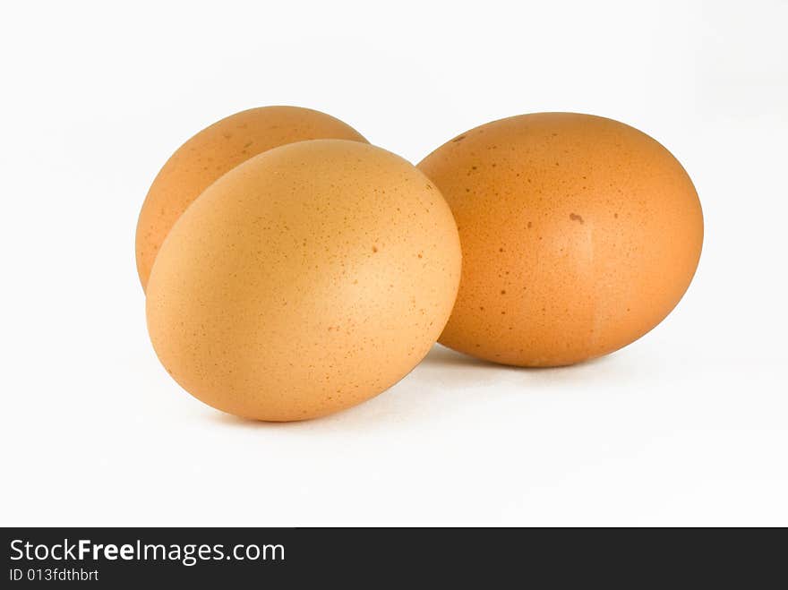 Three chicken eggs on a white background. Three chicken eggs on a white background