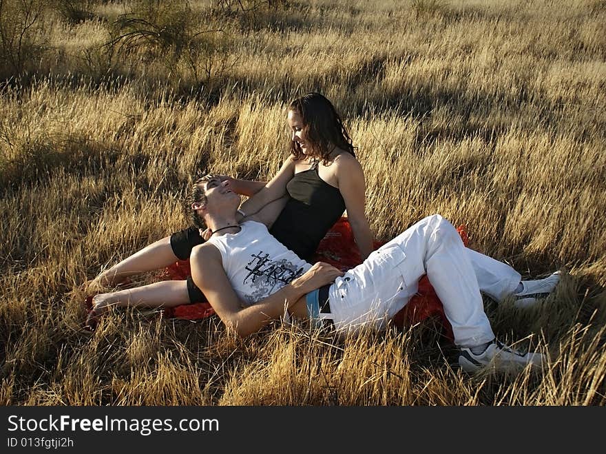 Boy And Girl On The Grass