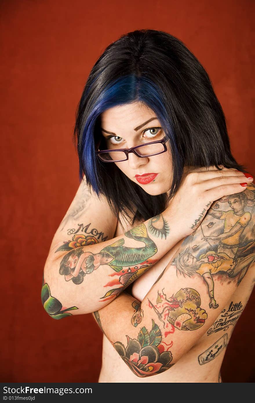 Woman with tattoos and crossed arms