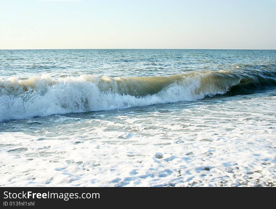 Abstract scene with wave on sea beach under year blue sky