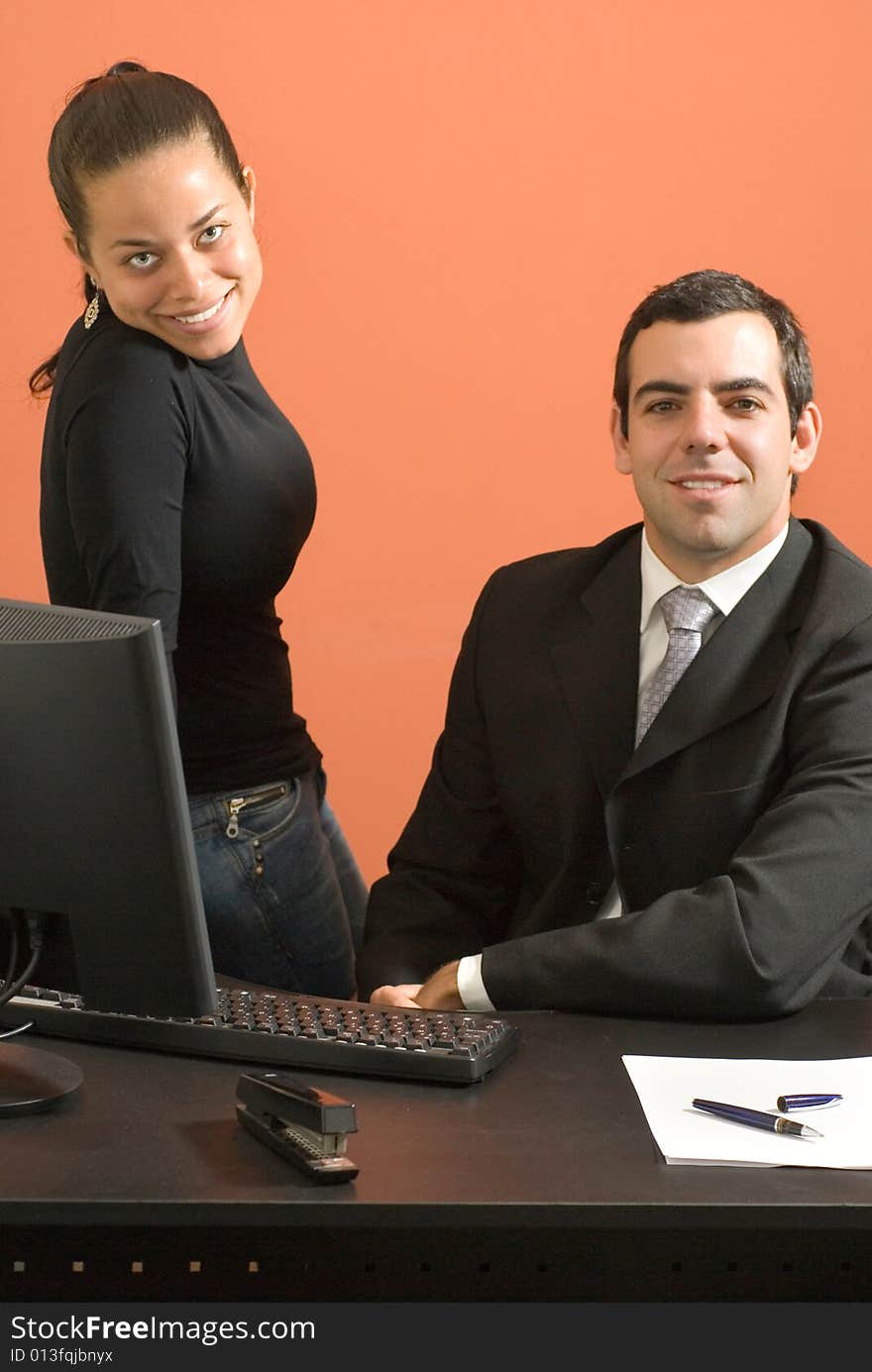 Businessman and woman working in an office. Businessman and woman working in an office.