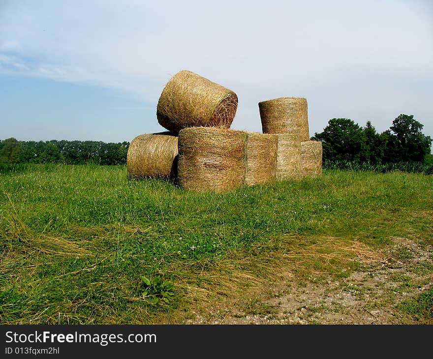 Bales of hay out in a field. Horizontally framed photo. Bales of hay out in a field. Horizontally framed photo.