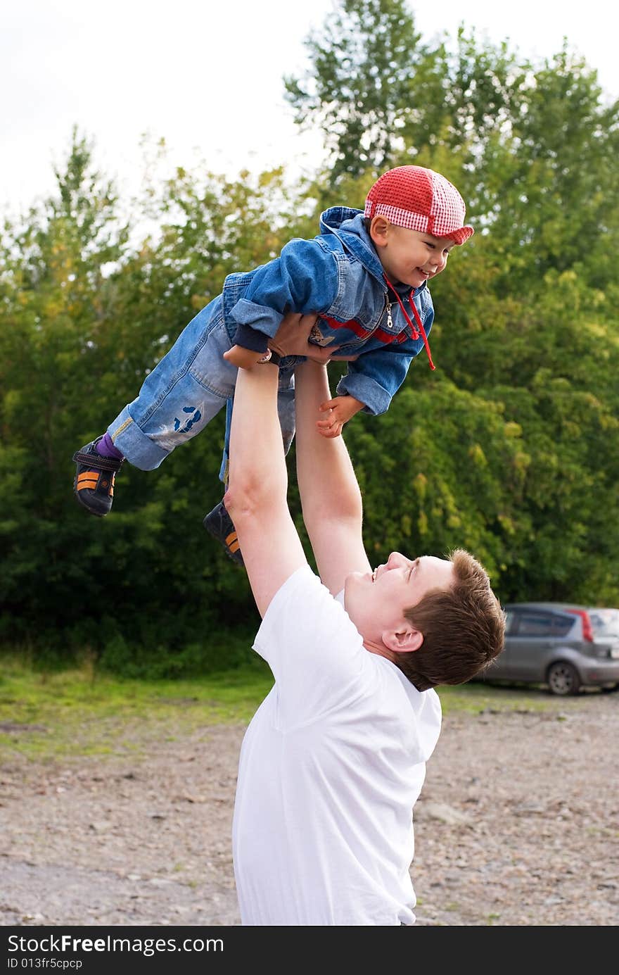 Father and little son playing outdoor. Father and little son playing outdoor