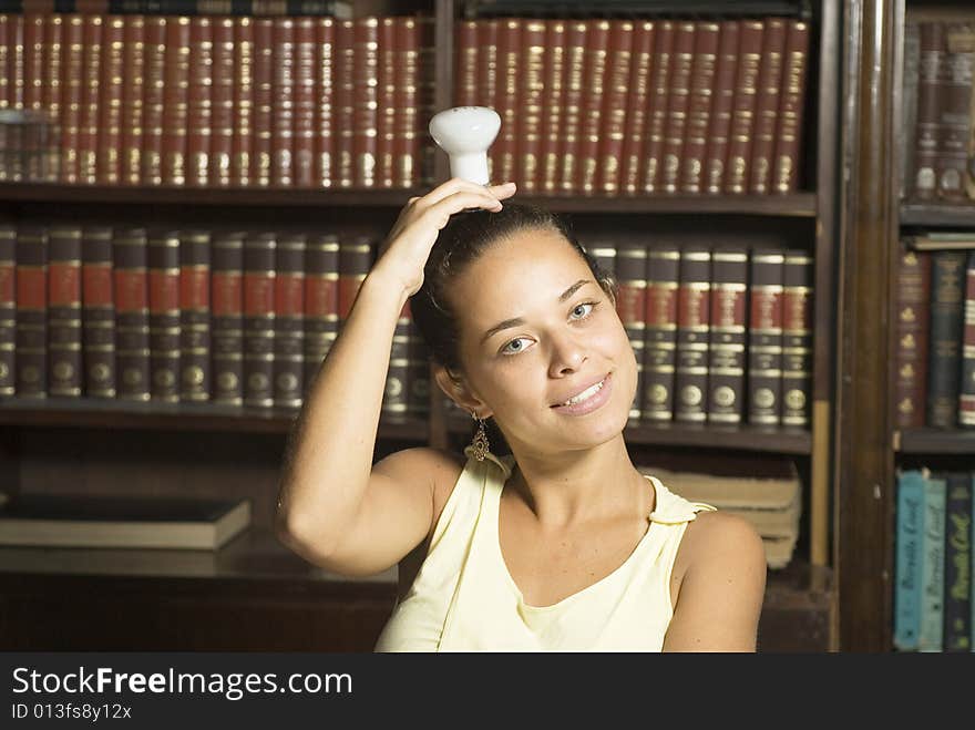 Smiling girl with lightbulb on her head. Horizontally framed photo. Smiling girl with lightbulb on her head. Horizontally framed photo.