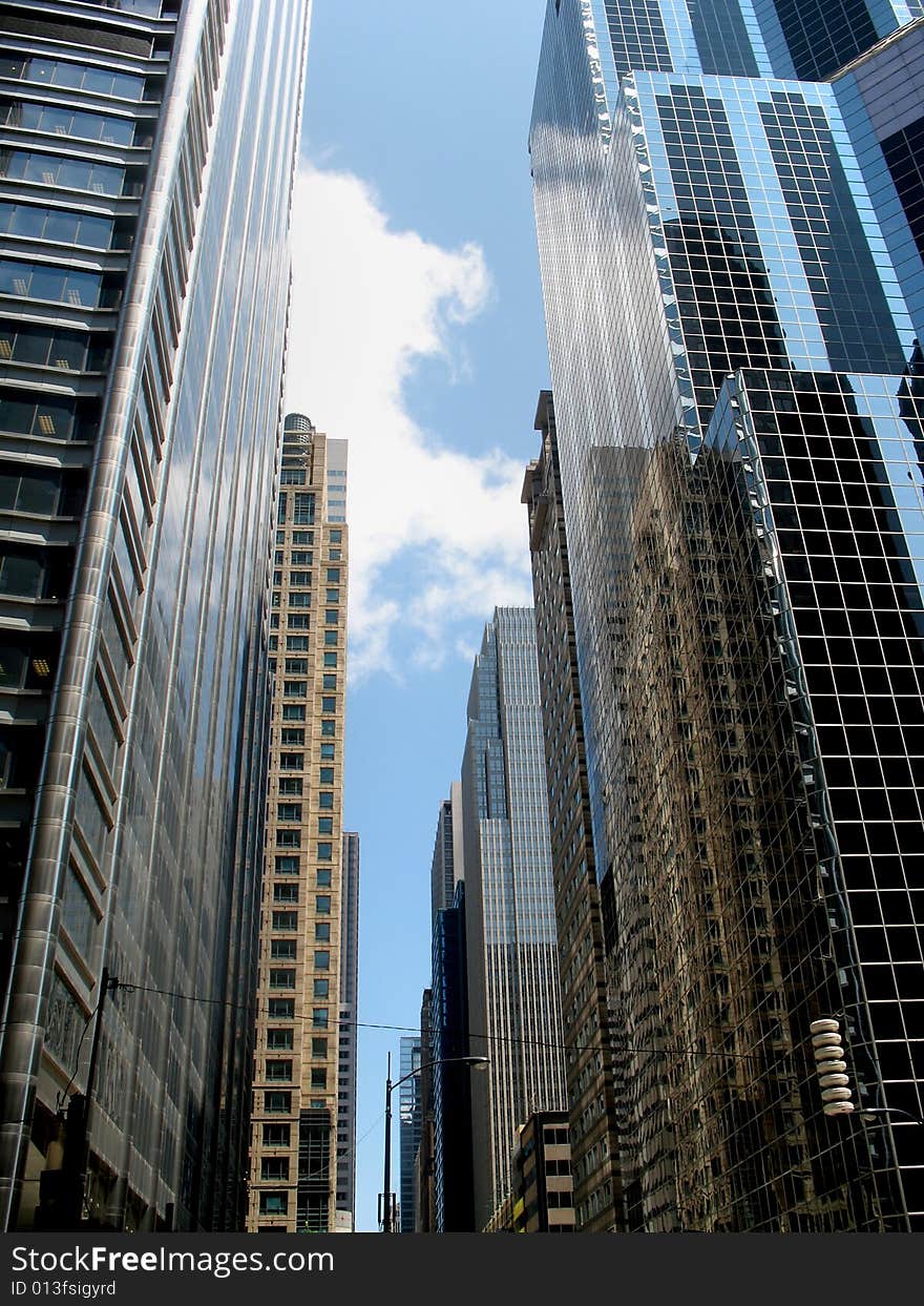 View from below a group of tall buildings. Vertically framed photo. View from below a group of tall buildings. Vertically framed photo.