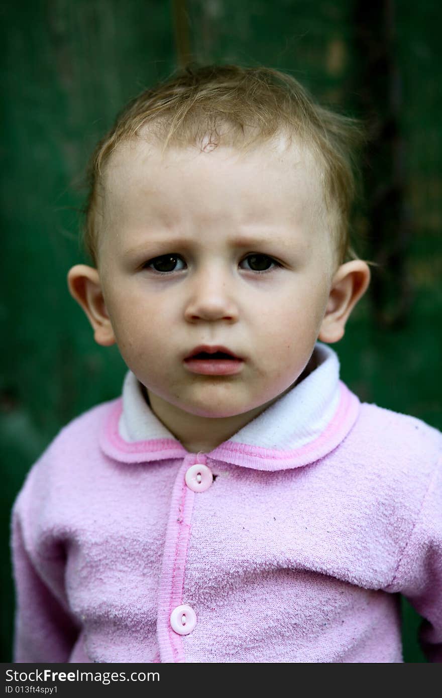 Baby-girl near fence