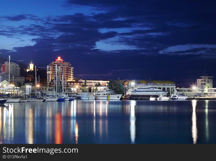 Night city. illuminated a pier with yachts . Night city. illuminated a pier with yachts .