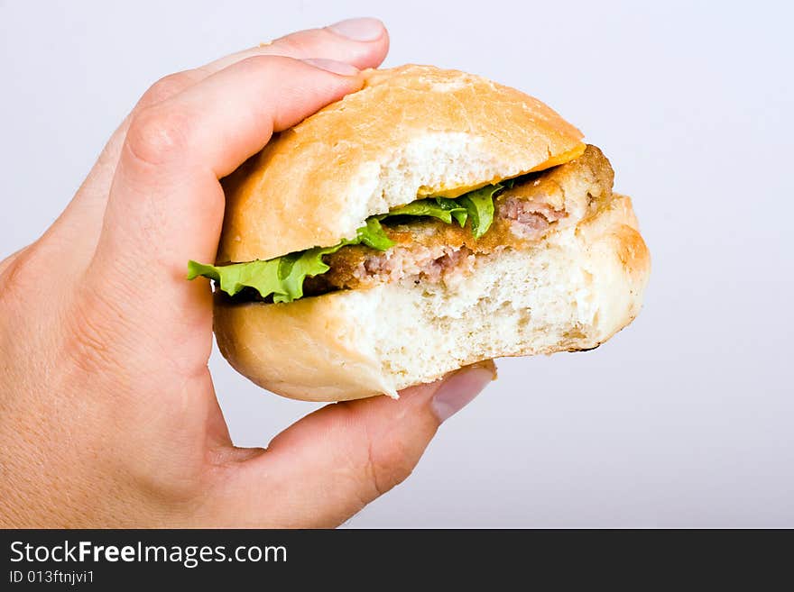 An image of hamburger in mans hand. An image of hamburger in mans hand