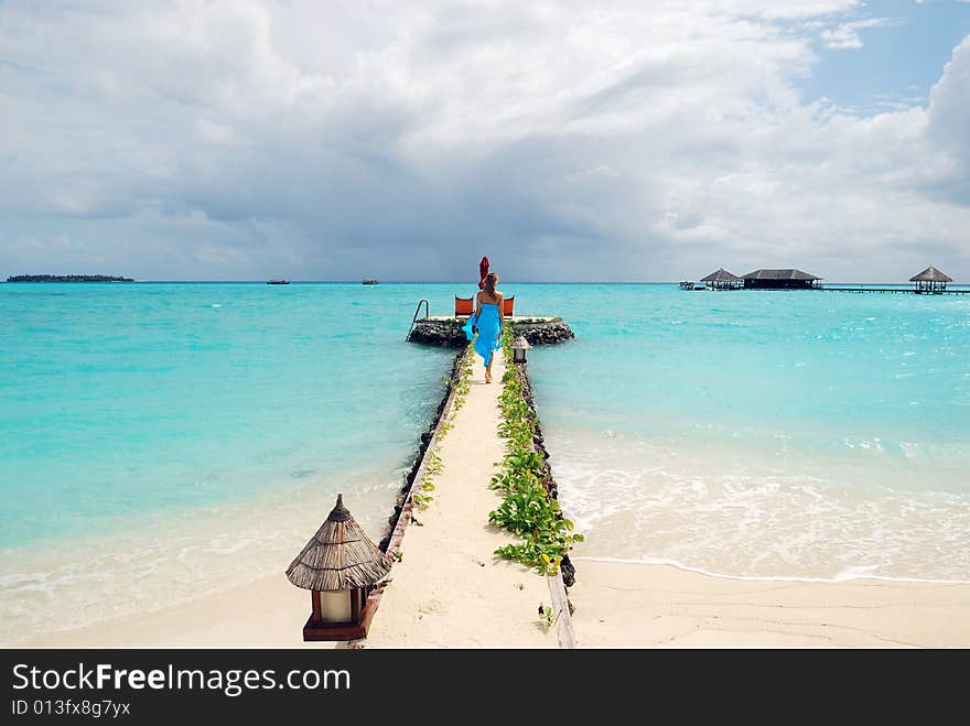 Happy woman walking on the tropical beach