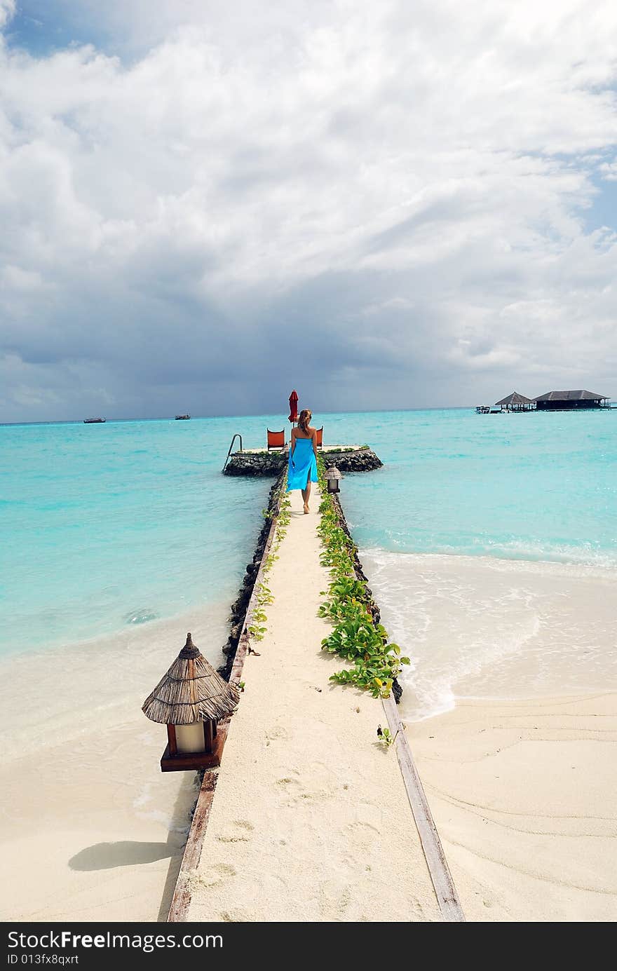 Happy woman walking on the tropical beach