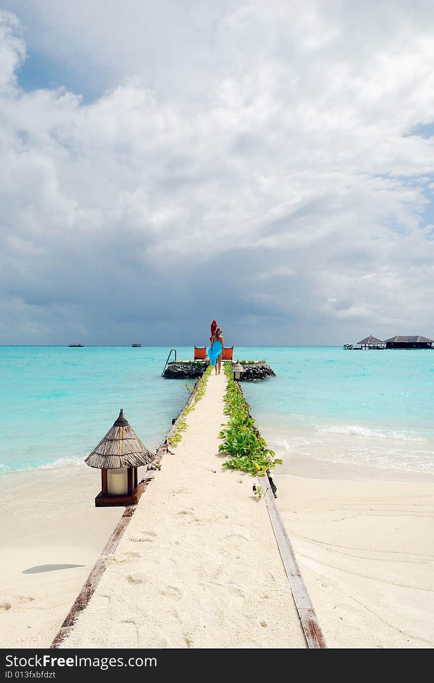 Happy woman walking on the tropical beach