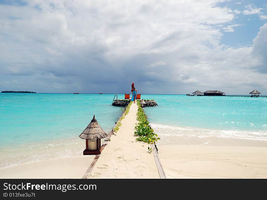 Happy woman walking on the tropical beach