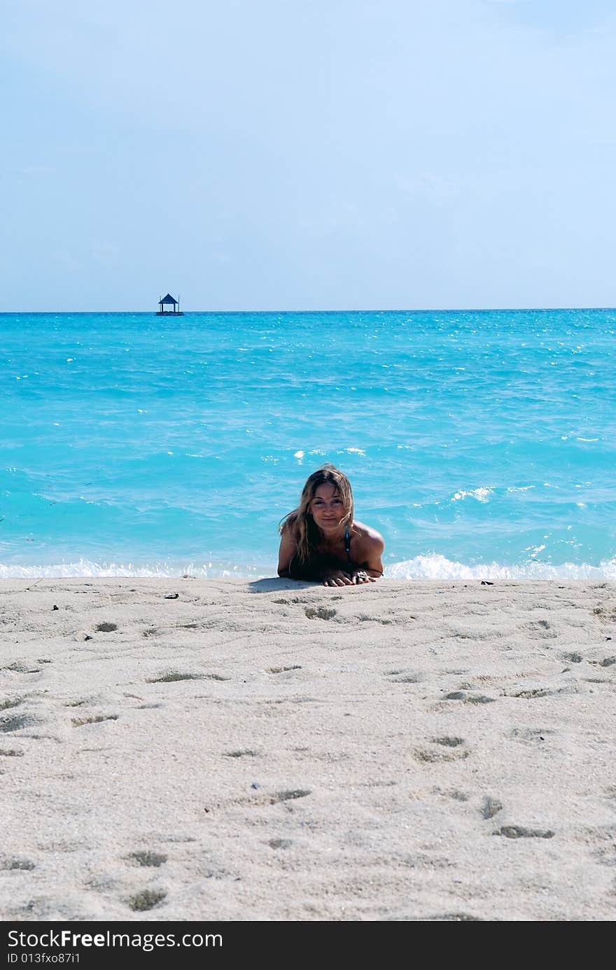 Woman looking at the ocean on the tropical beach. Woman looking at the ocean on the tropical beach