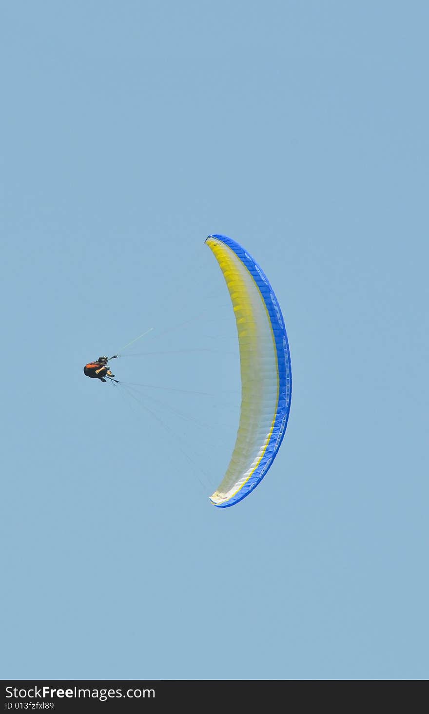 An accro paraglider pilot in the air. An accro paraglider pilot in the air