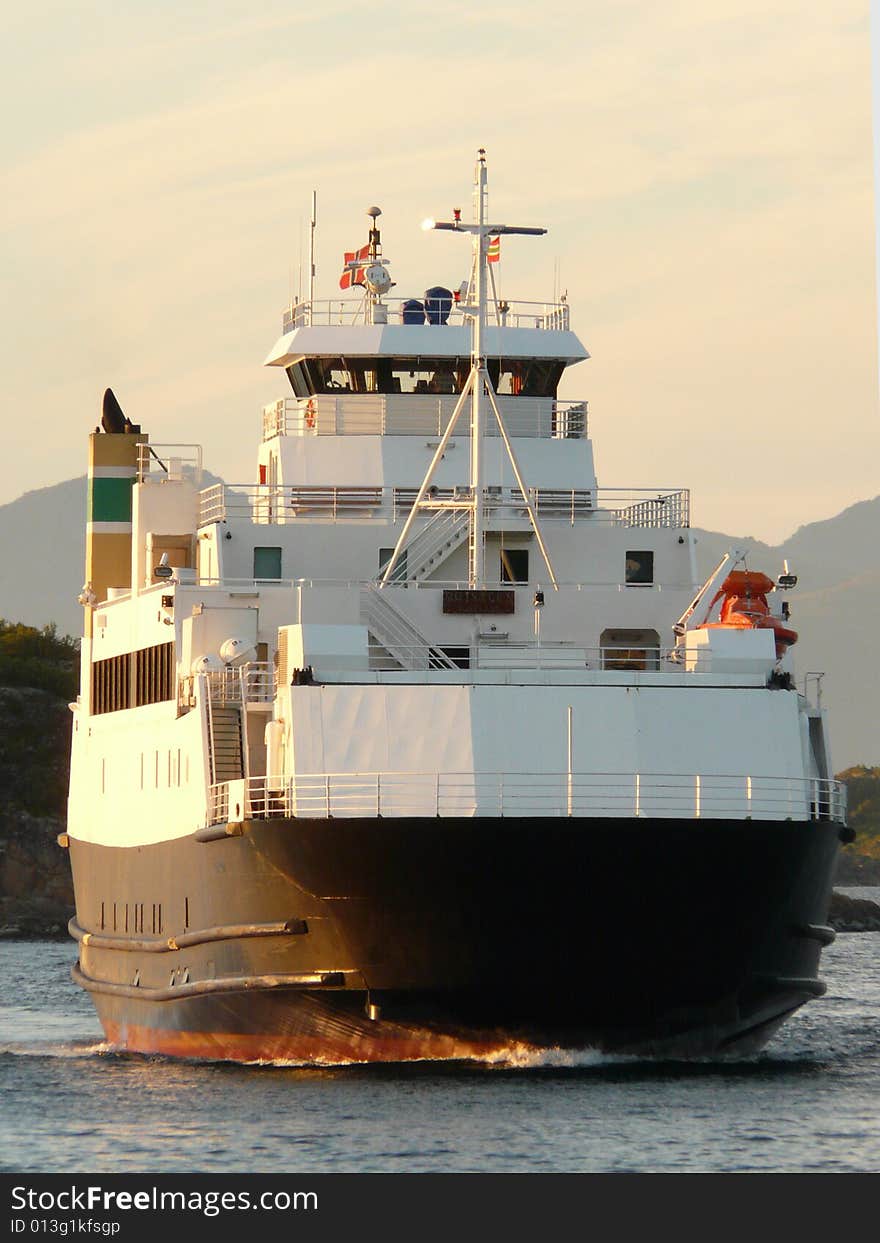 Norwegian ferry mooring at midnight in Fiskebol, Lofoten islands, norwegian arctic sea. Norwegian ferry mooring at midnight in Fiskebol, Lofoten islands, norwegian arctic sea