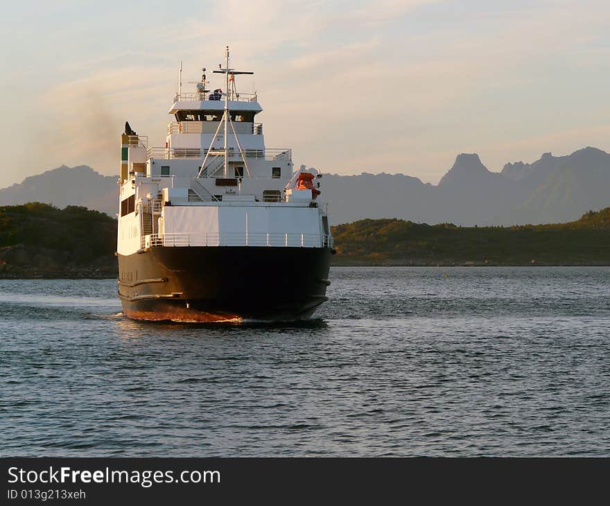 Norwegian ferry mooring at midnight in Fiskebol, Lofoten islands, norwegian arctic sea. Norwegian ferry mooring at midnight in Fiskebol, Lofoten islands, norwegian arctic sea