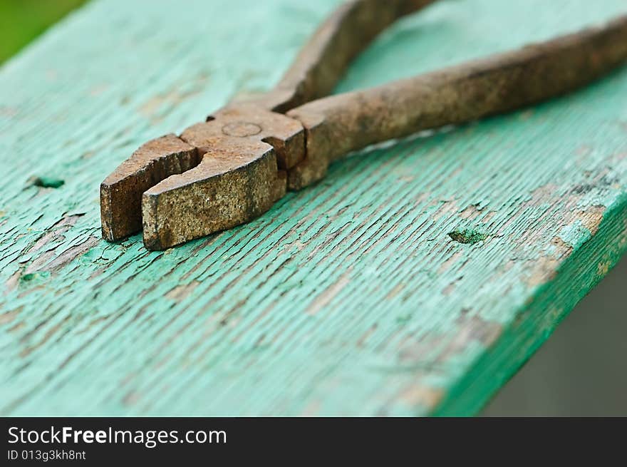 Old iron rusty pliers with blured background