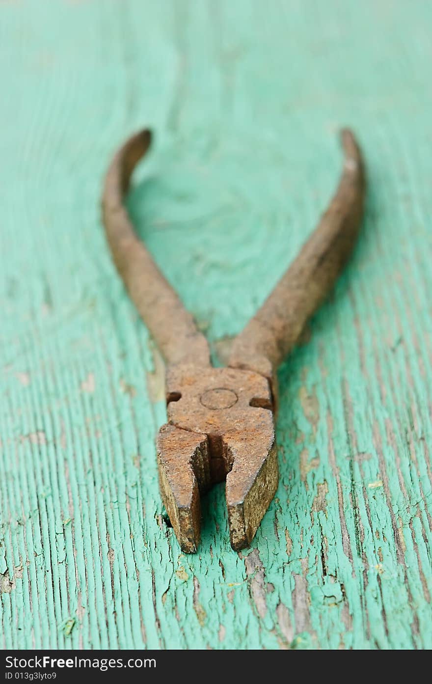 Old iron rusty pliers with blured background