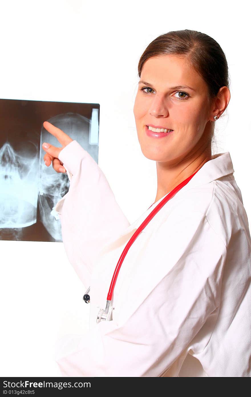 A beautiful young doctor with a red stethoscope and a xray image in the back. Isolated over white. A beautiful young doctor with a red stethoscope and a xray image in the back. Isolated over white.