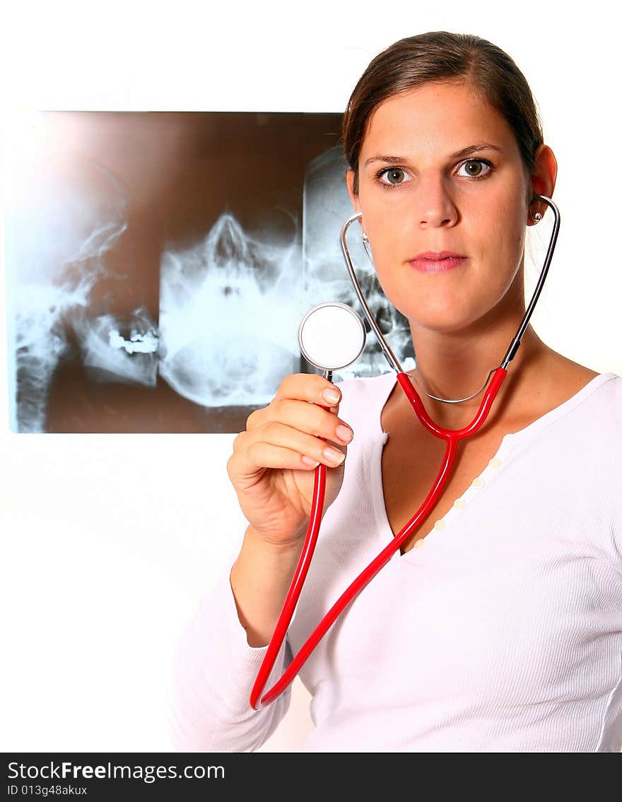 A beautiful young doctor with a red stethoscope and a xray image in the back. Isolated over white. A beautiful young doctor with a red stethoscope and a xray image in the back. Isolated over white.