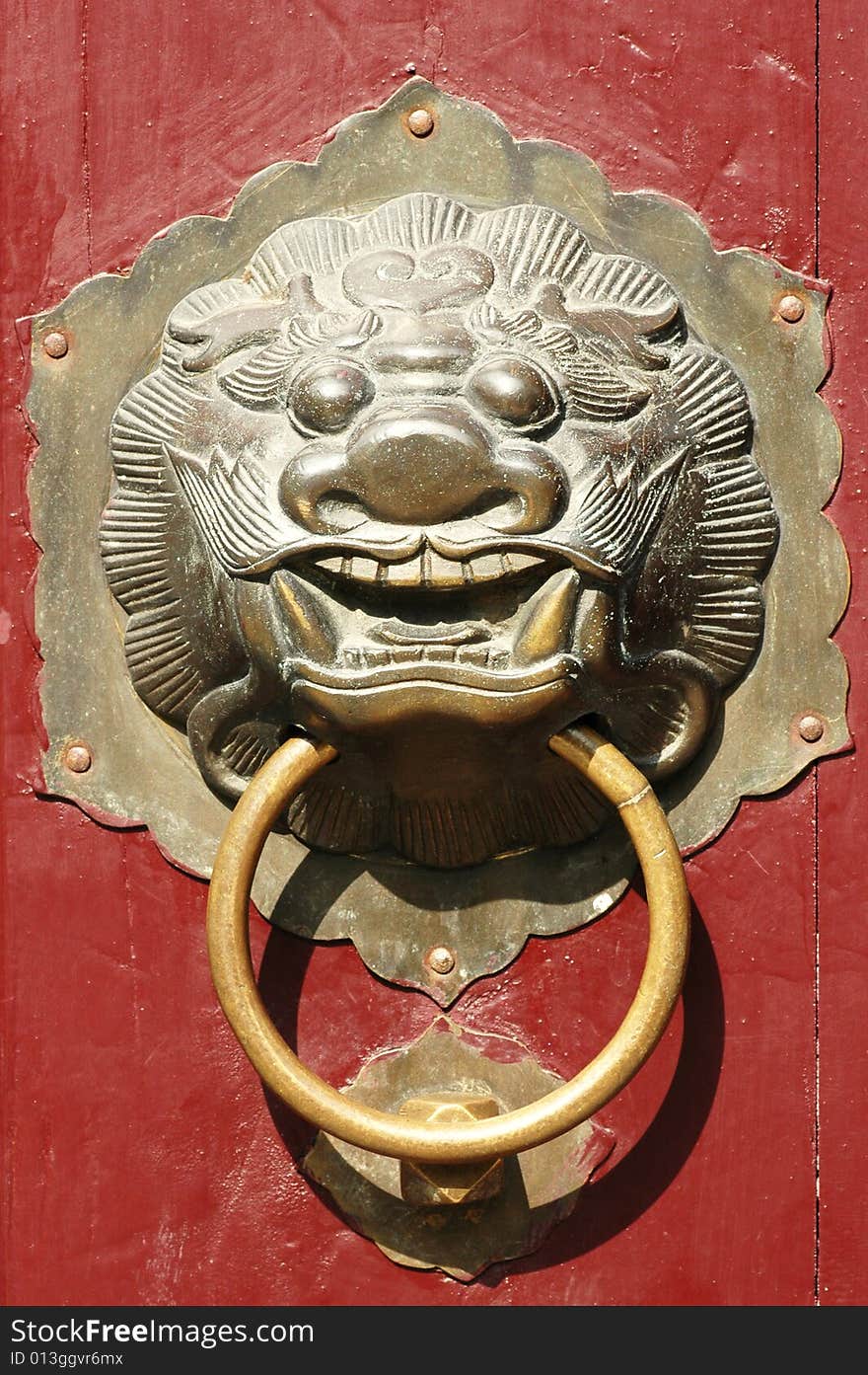 Close up of traditional oriental Chinese lion door knob. Close up of traditional oriental Chinese lion door knob