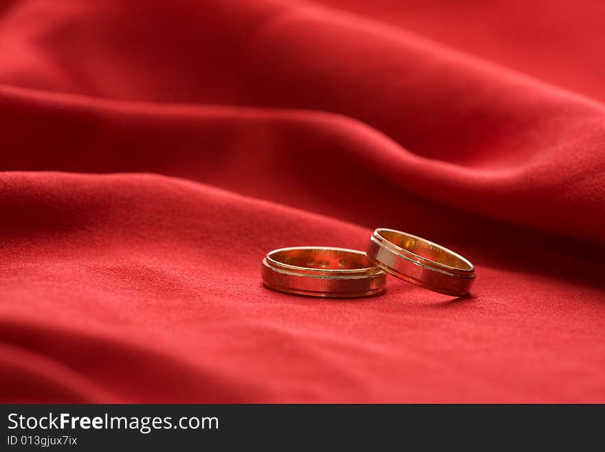 Wedding rings on a red background