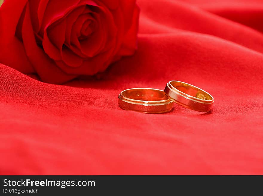 Wedding rings and red rose