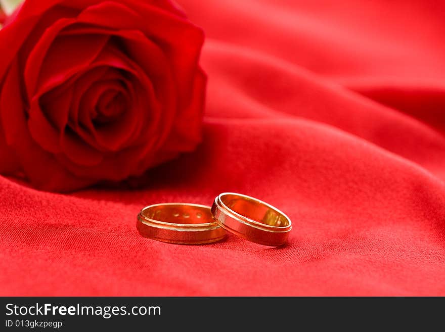 Wedding rings and red rose