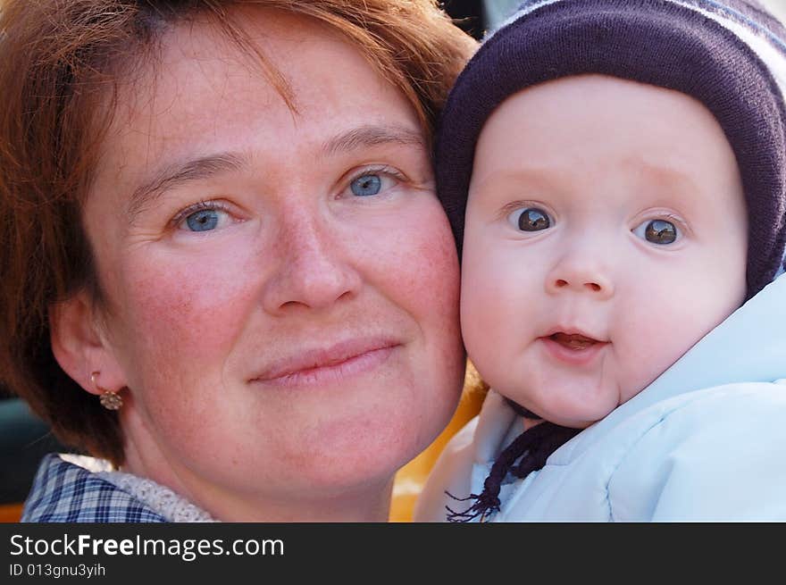 Mother and baby look in camera