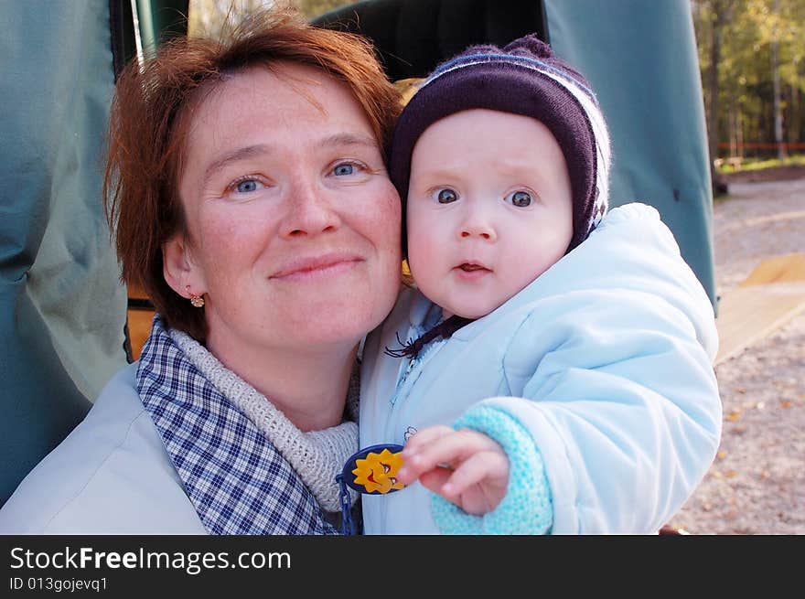 Happy mother and baby look in camera