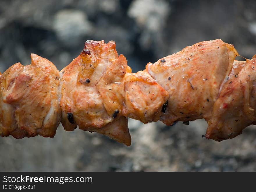 A fried meat on coals