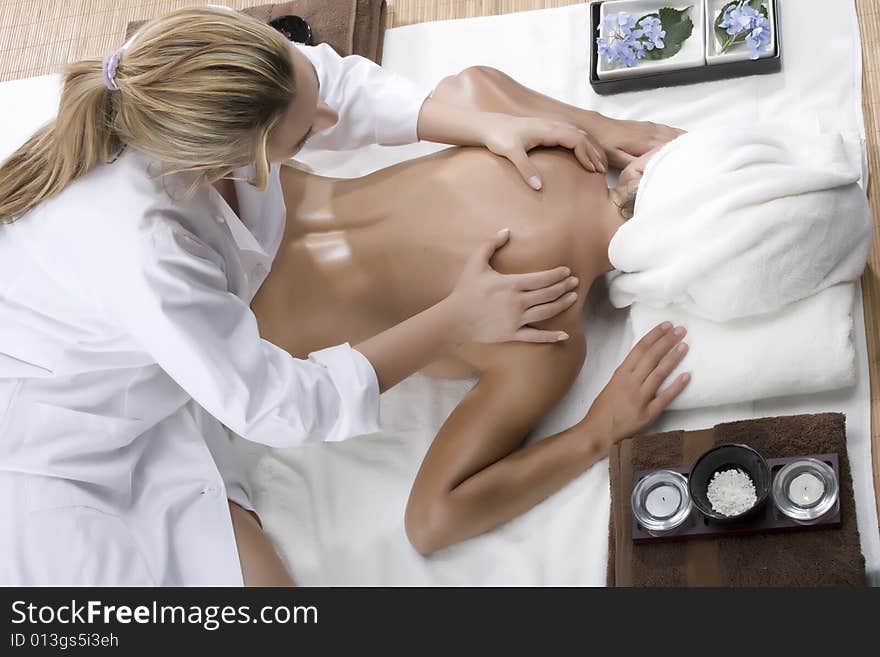 Woman in a day spa getting a deep tissue massage therapy