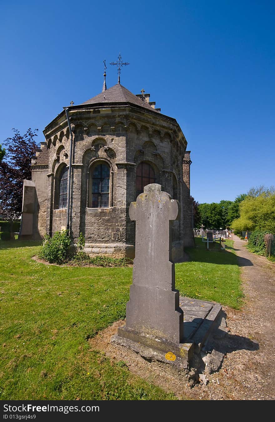 Medieval church eith a tombstone infront on a sunny day with bright blue sky. Medieval church eith a tombstone infront on a sunny day with bright blue sky