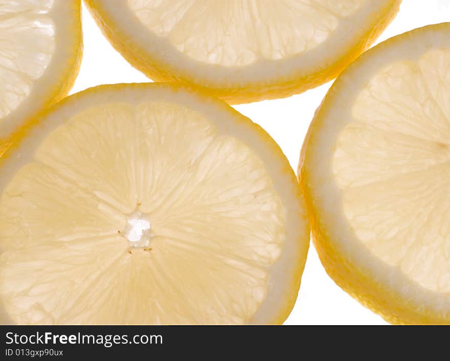 Sliced lemons in cross section back lit and slightly translucent. Sliced lemons in cross section back lit and slightly translucent