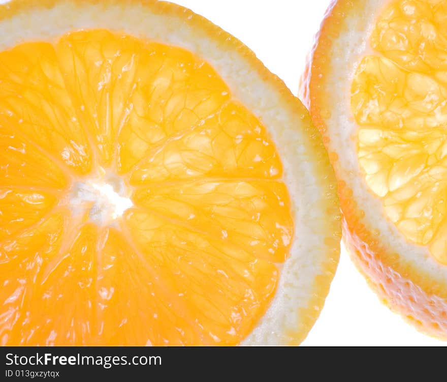 Sliced oranges in cross section back lit and slightly translucent. Sliced oranges in cross section back lit and slightly translucent