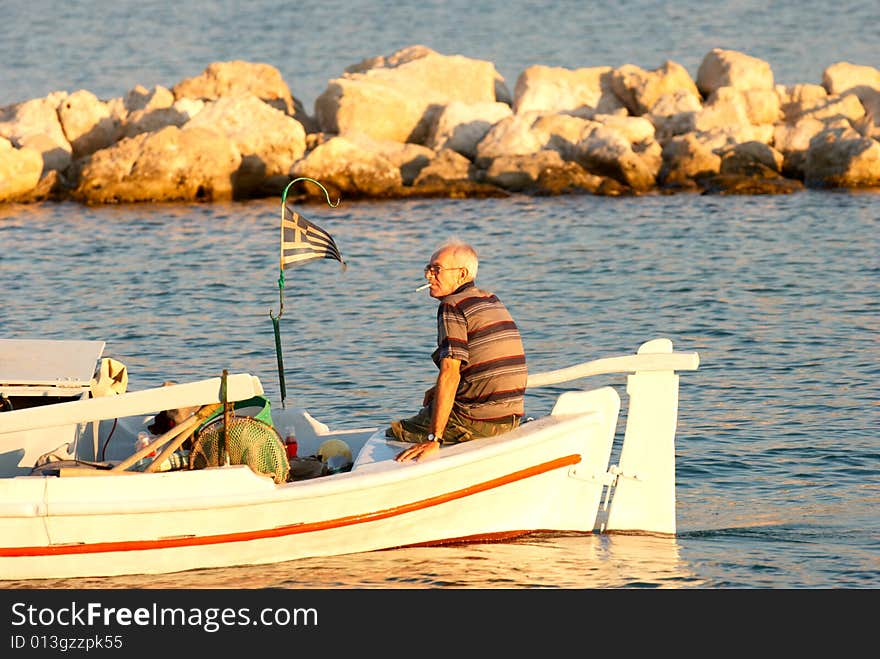 Old boatman in the sunset