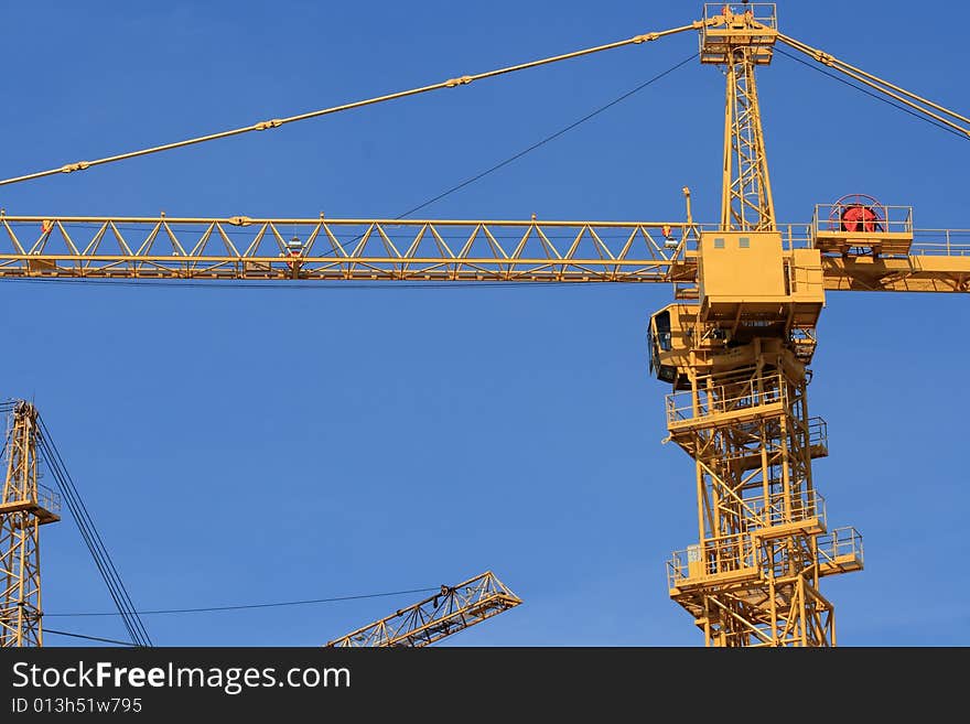 Yellow crane on a blue sky background