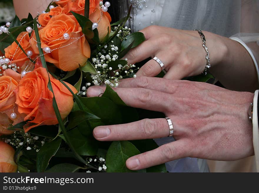 Nice orange roses from the wedding and hands. Nice orange roses from the wedding and hands