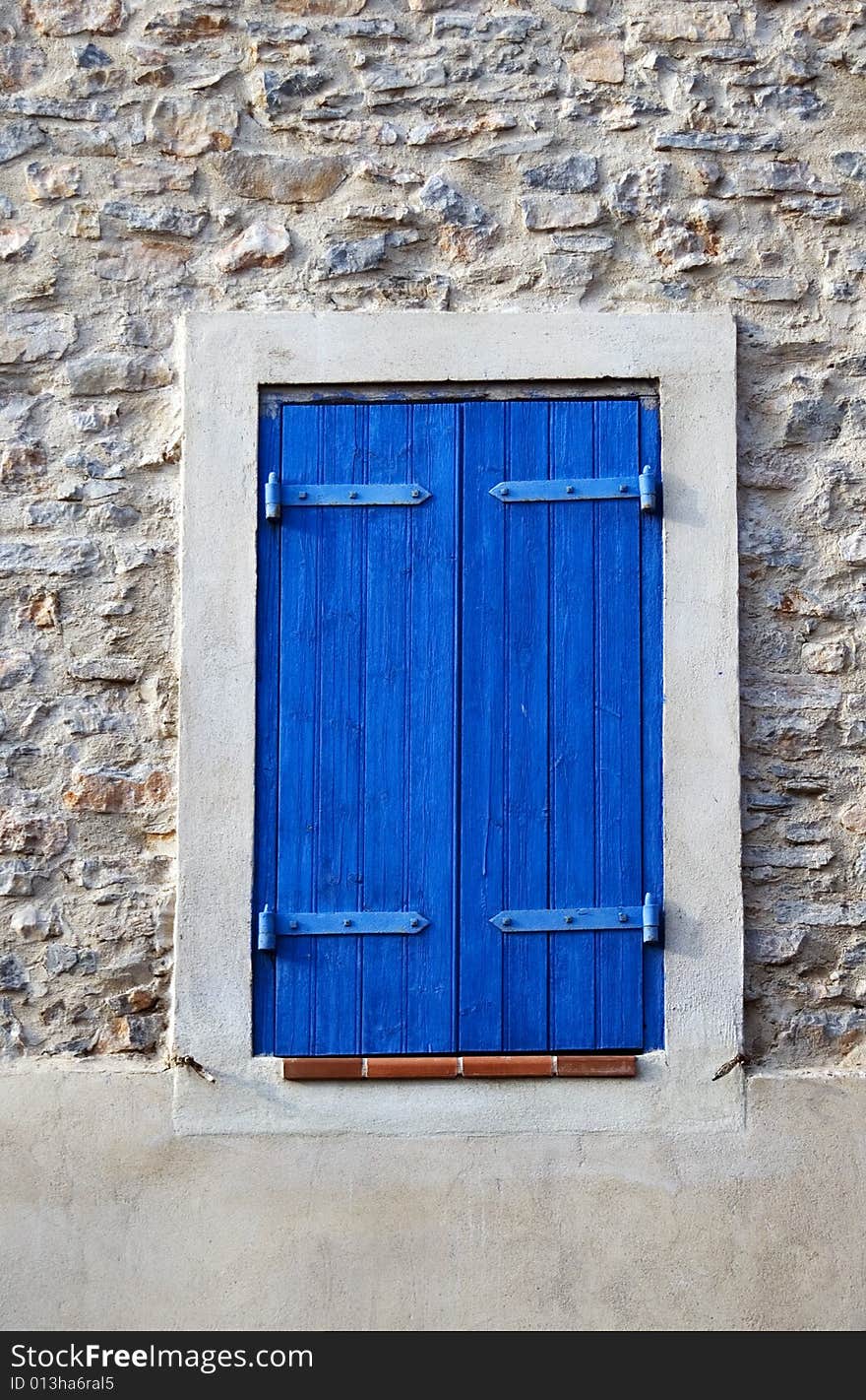 Window dark blue shutter in he stone wall, small town in France. Window dark blue shutter in he stone wall, small town in France