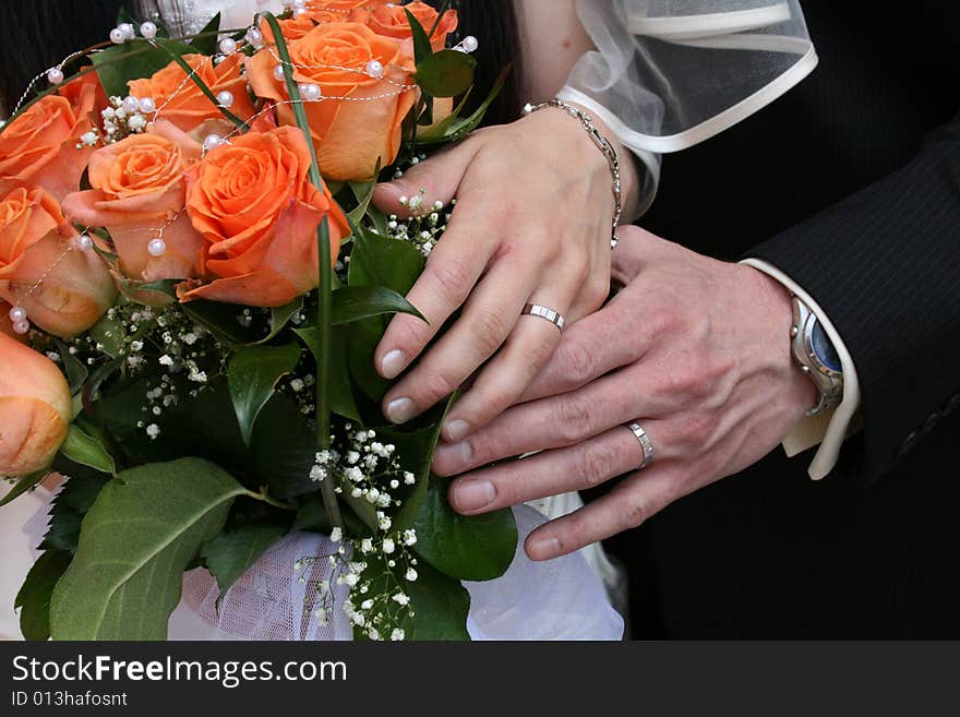 Nice orange roses from the wedding and hands. Nice orange roses from the wedding and hands