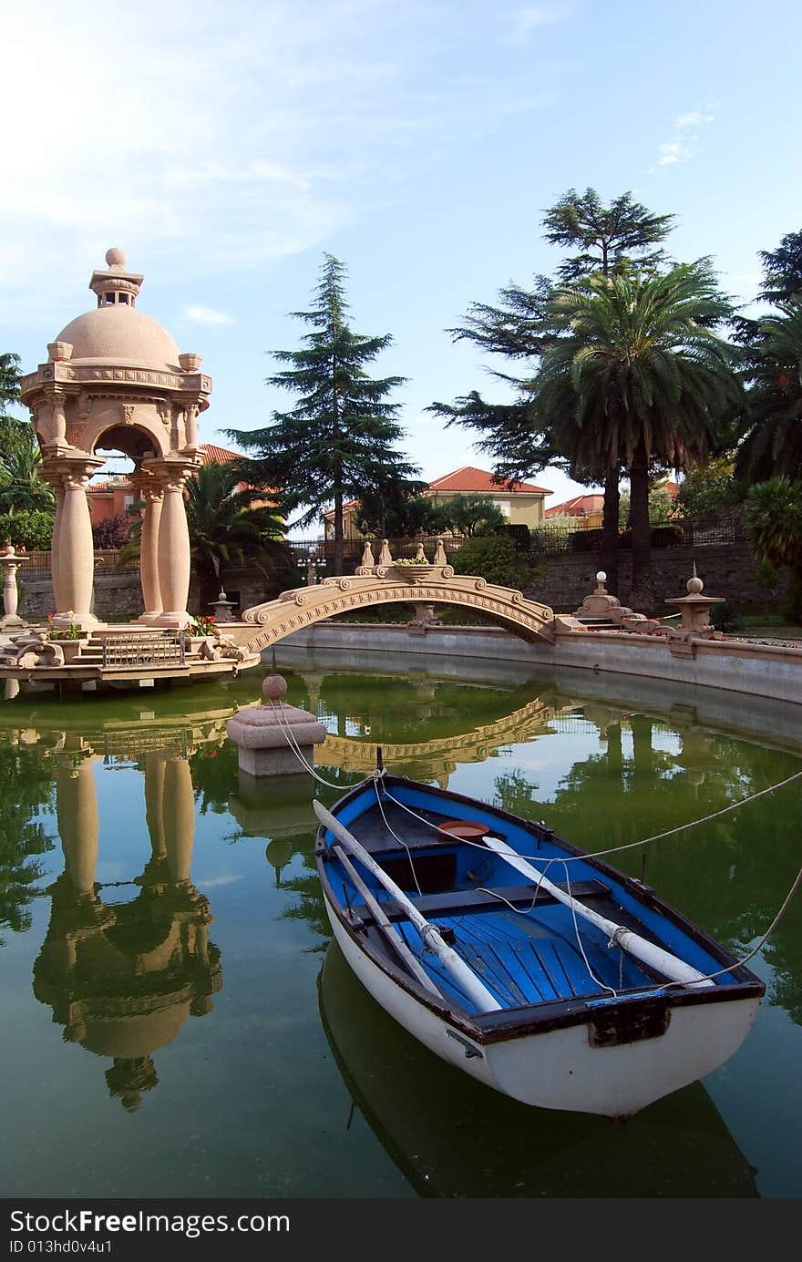 The fishpond with a bridge and a small temple in the park of Grock's Villa in Imperia, Liguria in Italy. 
Grock was the name of art of Adrien Wettach, the most famous clown of XX century. Grock was born in Reconvilier (Switzerland) in 1880 and he was consecrated Clown's King at the Olympia in Paris in 1919. He died in Imperia in 1958. The fishpond with a bridge and a small temple in the park of Grock's Villa in Imperia, Liguria in Italy. 
Grock was the name of art of Adrien Wettach, the most famous clown of XX century. Grock was born in Reconvilier (Switzerland) in 1880 and he was consecrated Clown's King at the Olympia in Paris in 1919. He died in Imperia in 1958.