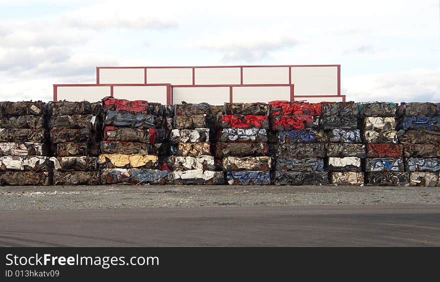 Buildings and pile of pressed cars in Tromsoe, norwegian arctic region. Buildings and pile of pressed cars in Tromsoe, norwegian arctic region