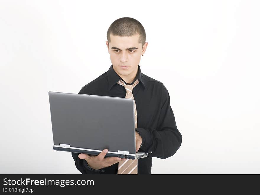 Young man in office with laptop. Young man in office with laptop