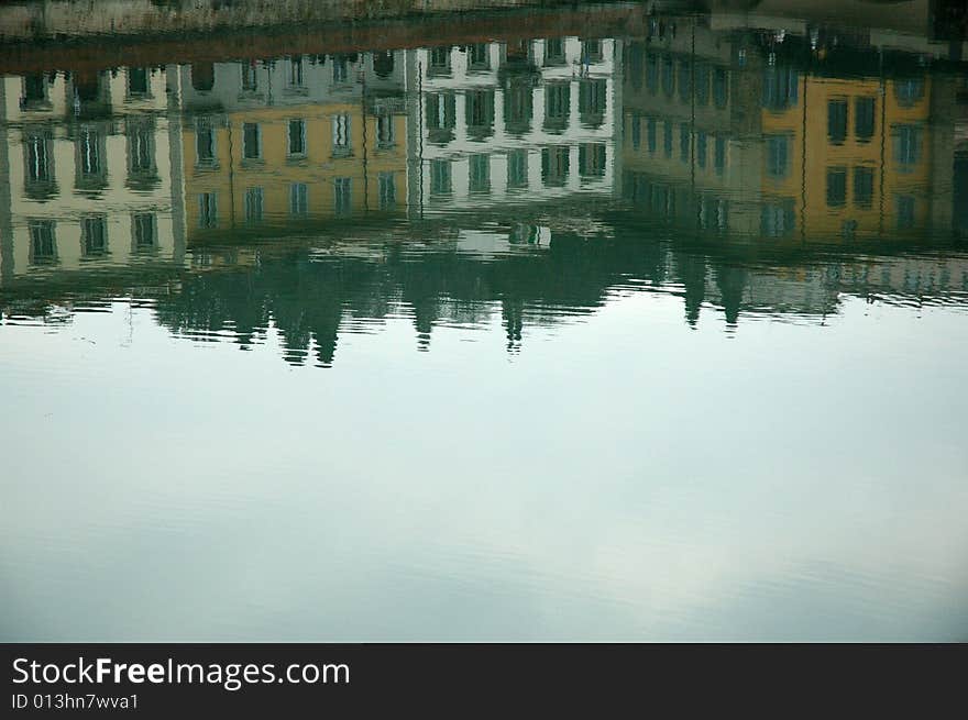 Buildings reflected on the river Arno